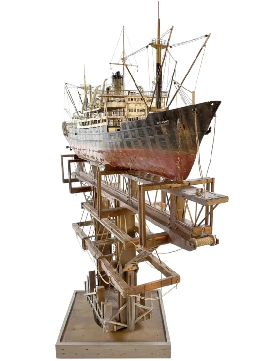 Artistic sculpture of the 'GHOST' cargo ship, crafted with intricate details to represent the industrial strength and mystique of a cargo vessel in a folk art style