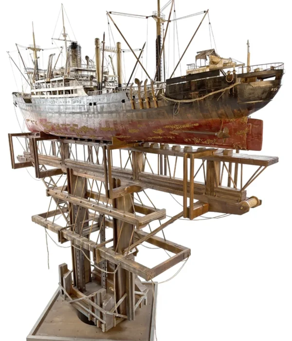 Artistic sculpture of the 'GHOST' cargo ship, crafted with intricate details to represent the industrial strength and mystique of a cargo vessel in a folk art style
