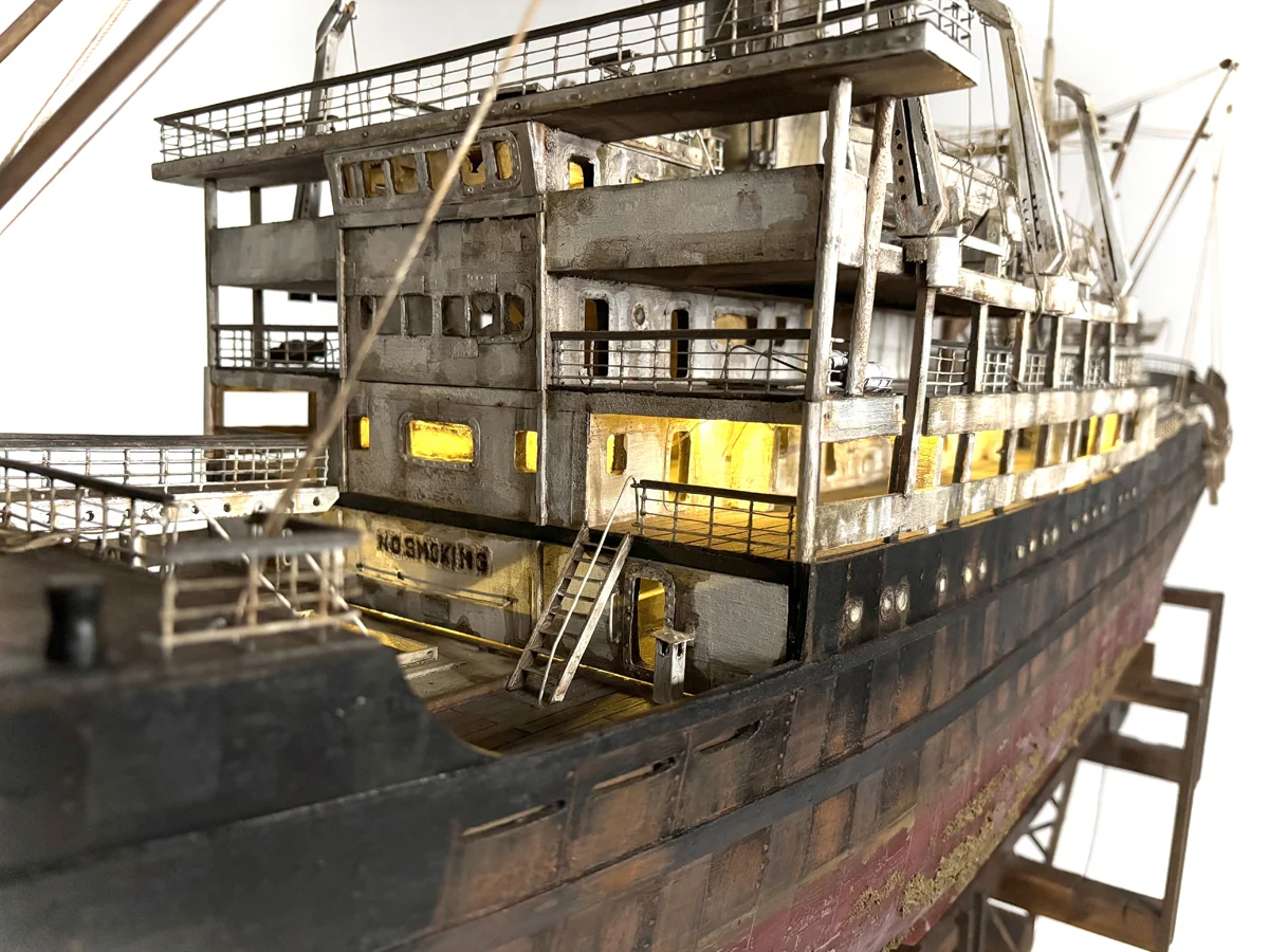 Artistic sculpture of the 'GHOST' cargo ship, crafted with intricate details to represent the industrial strength and mystique of a cargo vessel in a folk art style